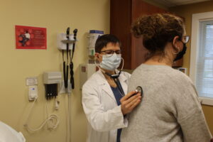 Doctor listening to patient's lungs.